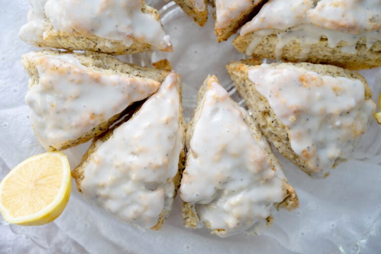 sourdough lemon poppy seed scones on a glass cake stand