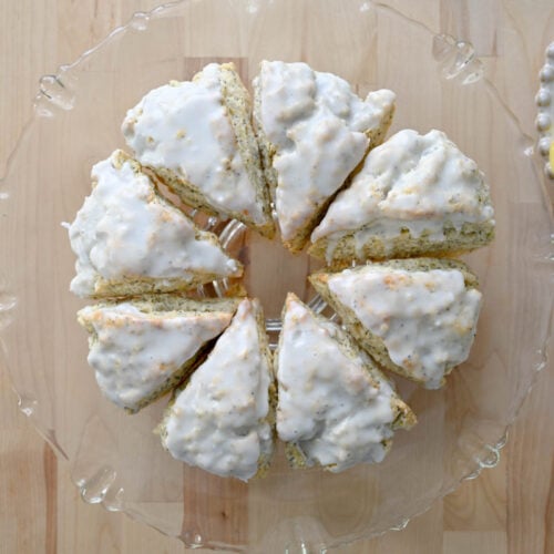 sourdough lemon poppyseed scones on a glass stand