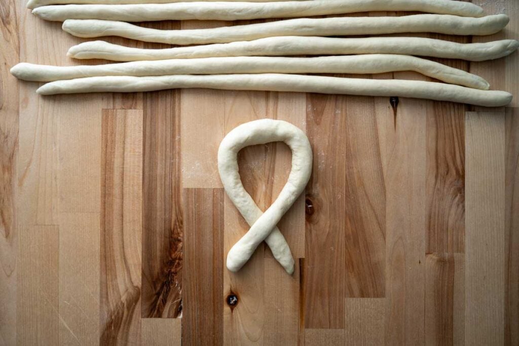 twisting sourdough pretzel dough ropes