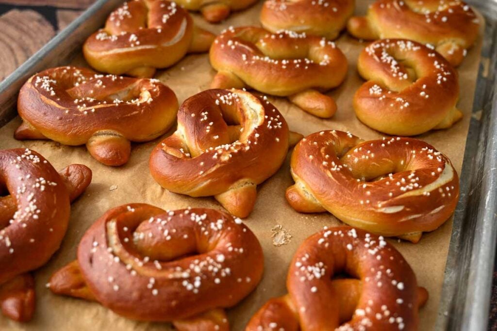 baked sourdough pretzels on a baking sheet