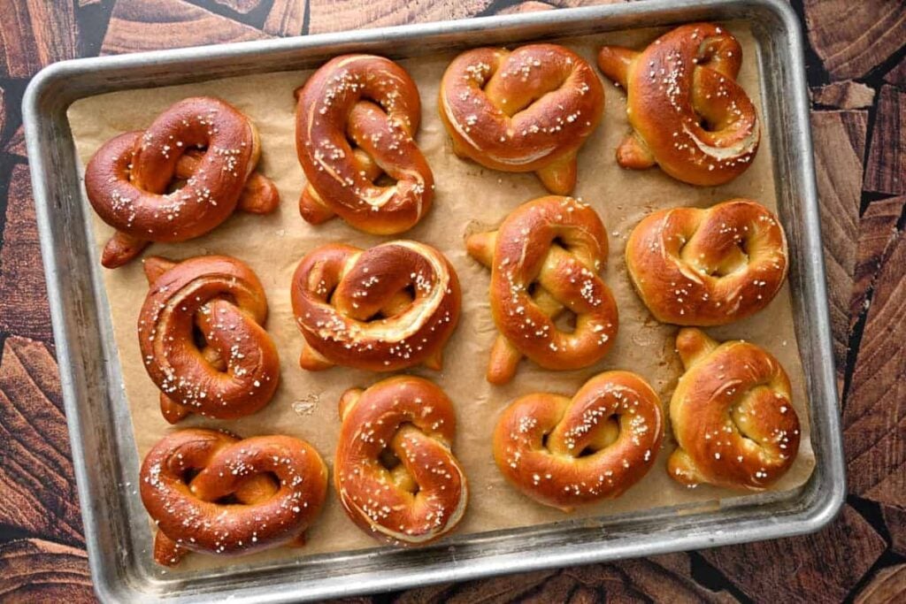 sourdough pretzels on a parchment lined baking sheet