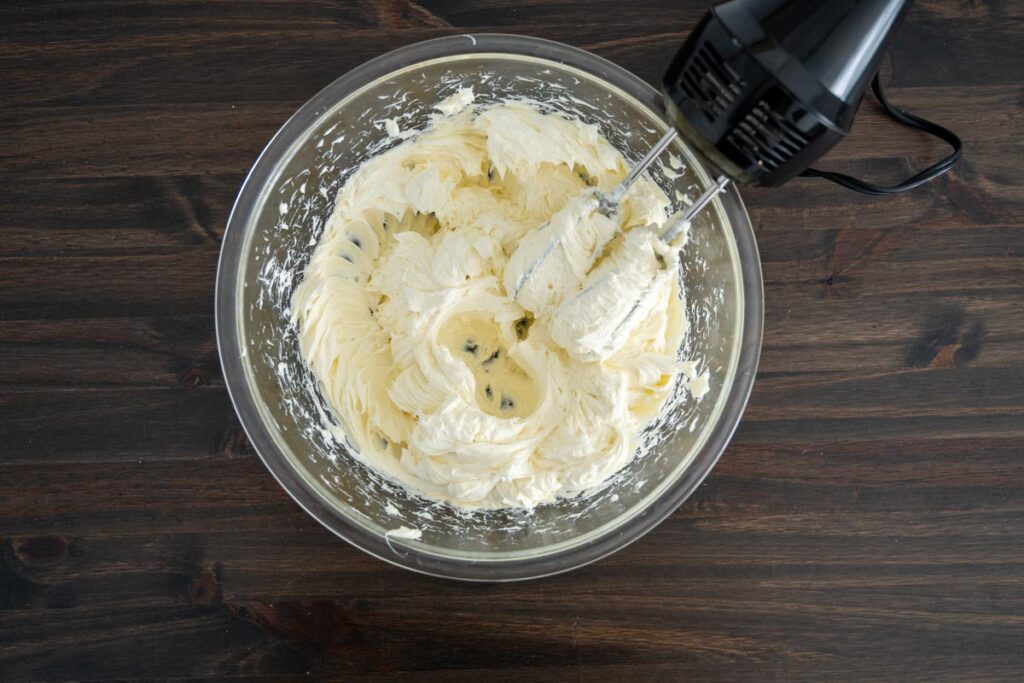 blended cream cheese in a glass bowl