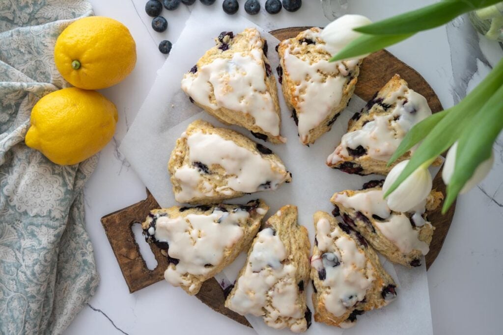 lemon blueberry sourdough scones on a wood platter