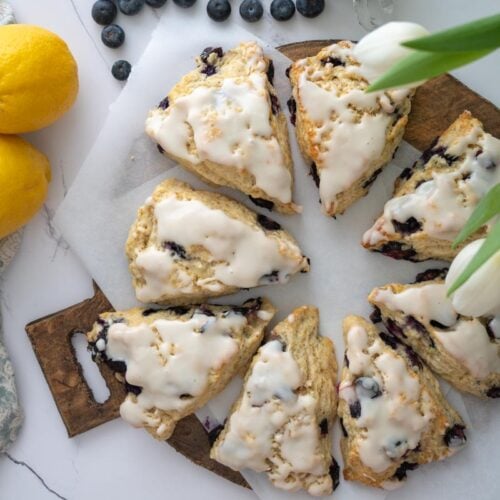 lemon blueberry sourdough scones on a wood platter