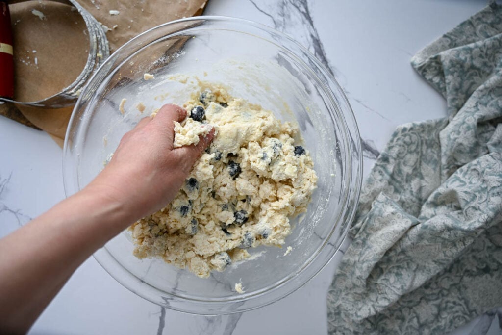 folding sourdough lemon blueberry scone dough with hand