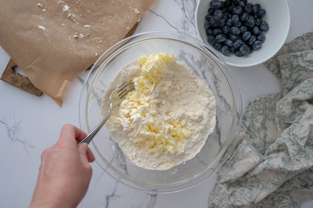 adding grated butter into flour mixture