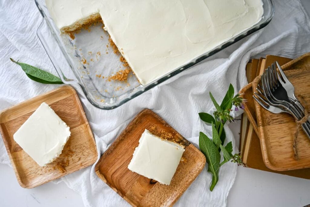 no bake cheesecake pieces on plates next to cake pan