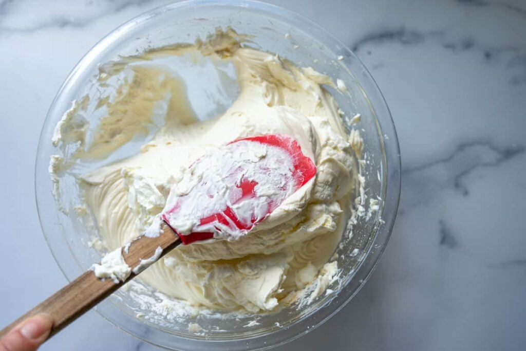 folding the whipped cream and cream cheese filling mixture together