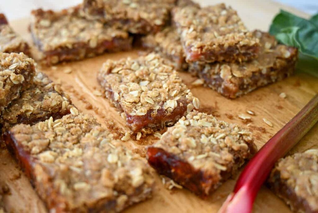 cut rhubarb bars on a wooden board