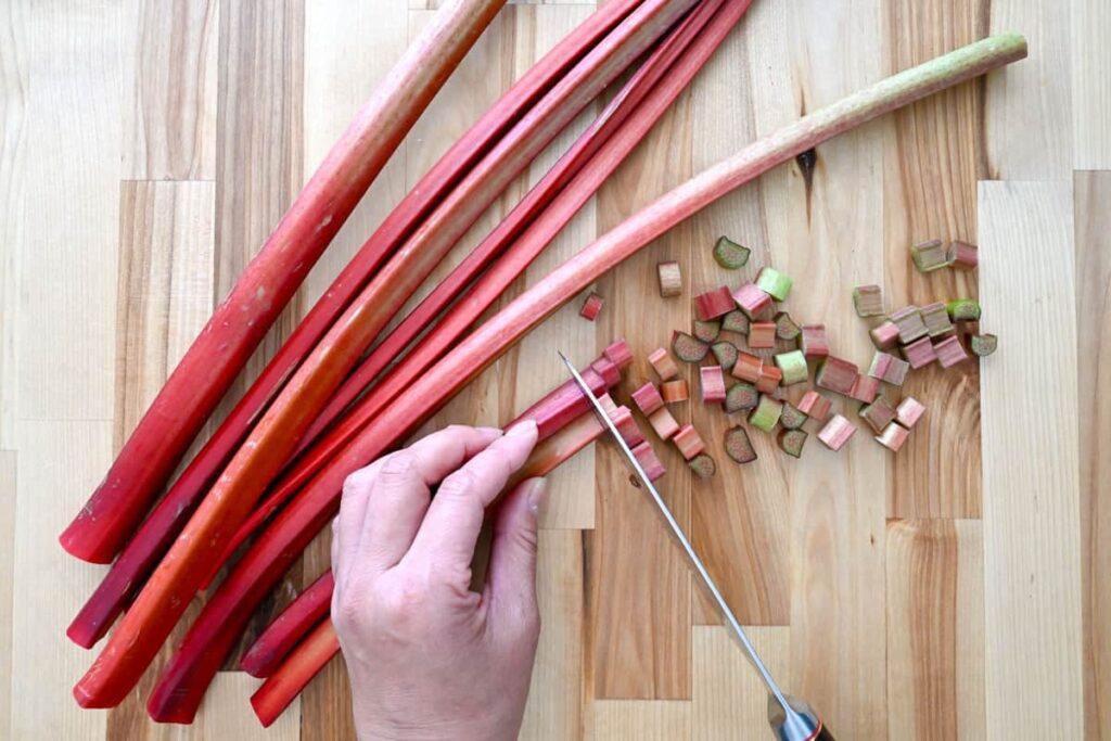 cutting rhubarb on a cutting board 