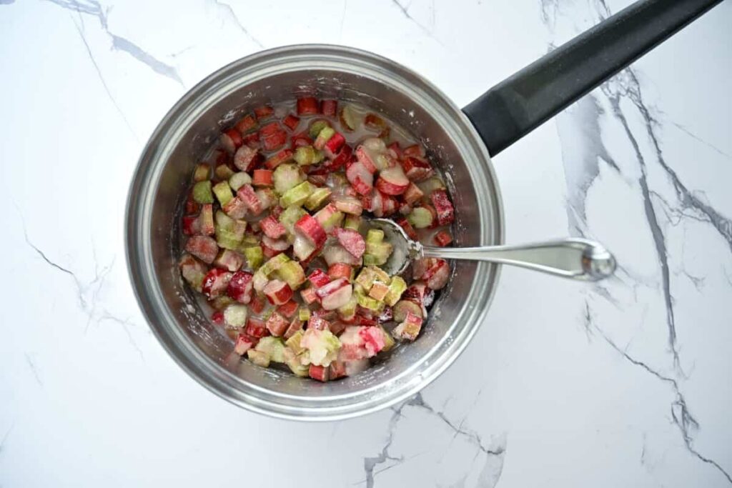 combining rhubarb compote in a saucepan