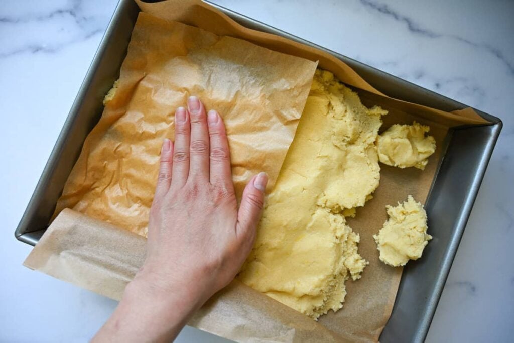 pressing the sourdough sugar cookie dough into a 9x13 baking pan