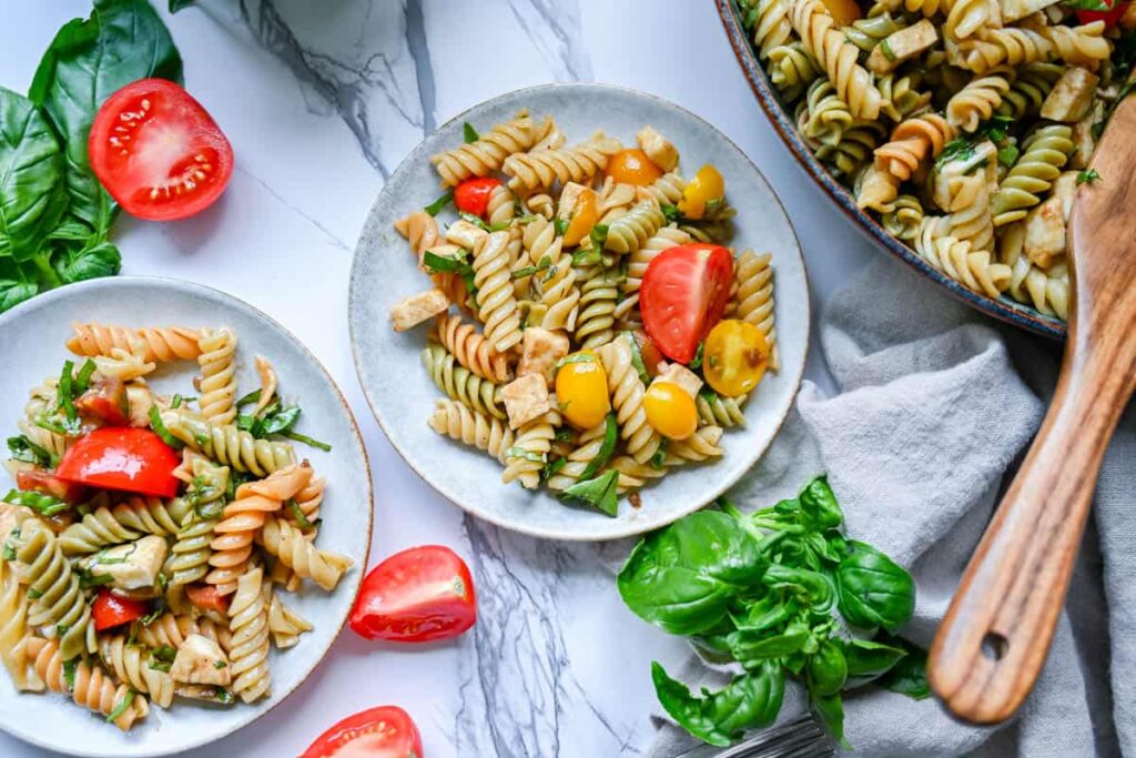 easy caprese pasta salad with balsamic vinaigrette on small plates