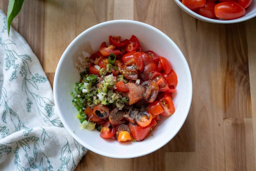 marinated tomatoes in a white bowl