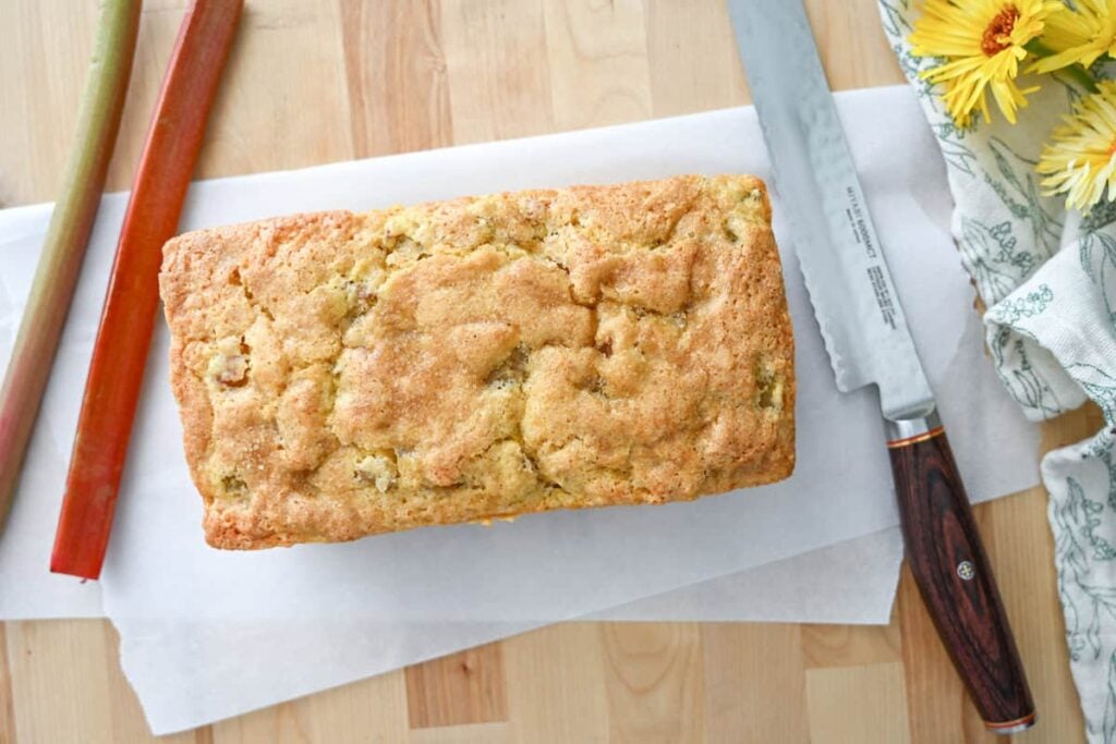 sourdough rhubarb quick bread on a piece of parchment paper
