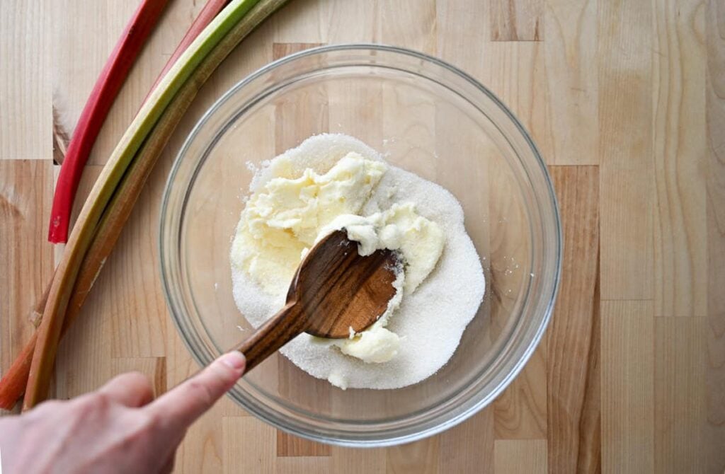 creaming butter and sugar in a glass bowl
