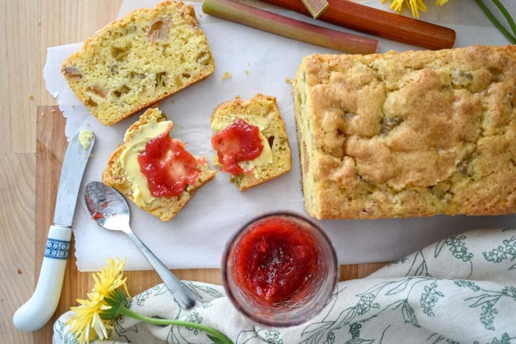 a slice of sourdough rhubarb bread with butter ands jam on it
