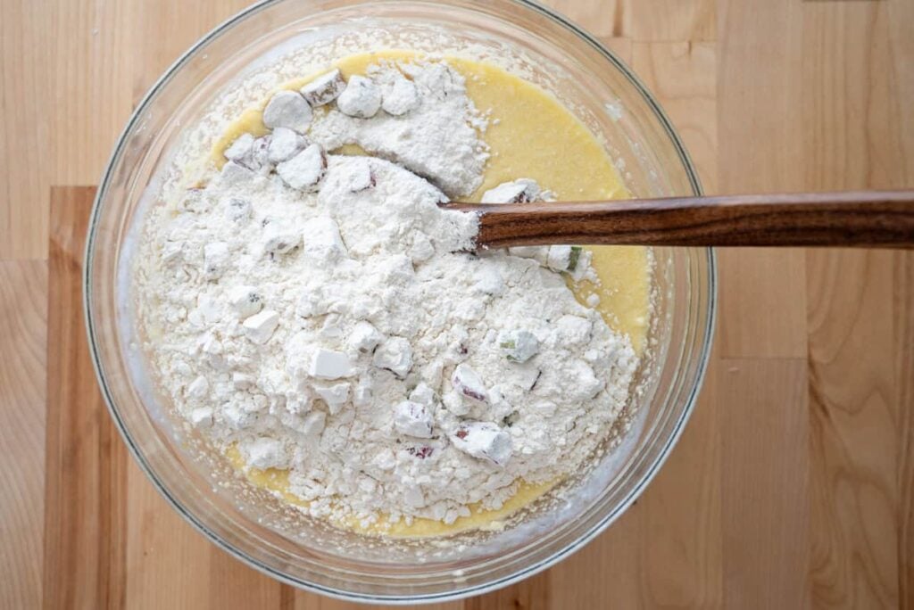 combing wet and dry ingredients for sourdough rhubarb bread in a glass bowl
