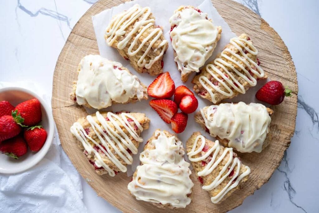 sourdough strawberry scones arranged on a wooden platter
