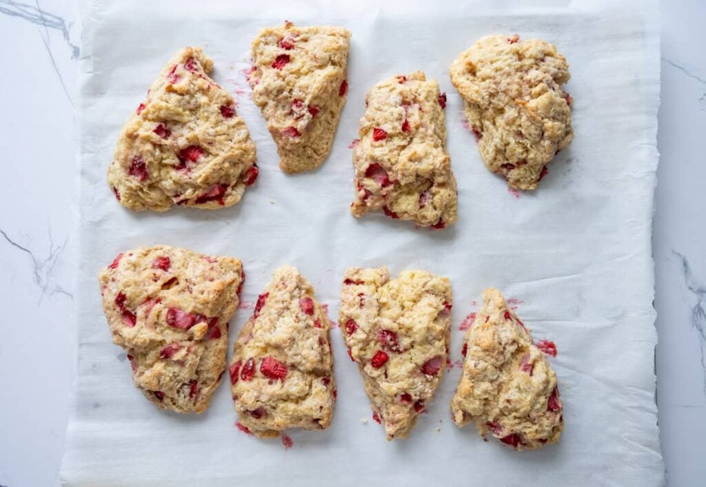 baked sourdough strawberry scones on a parchment lined baking sheet