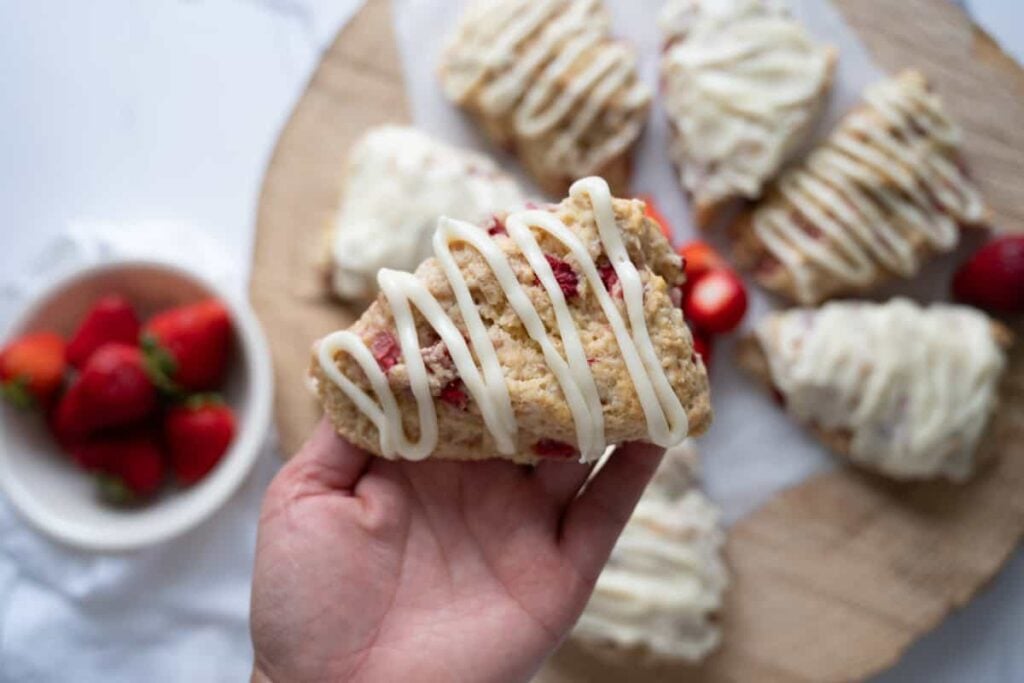 holding a sourdough strawberry scone