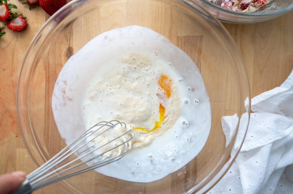 mixing wet ingredients in a glass bowl