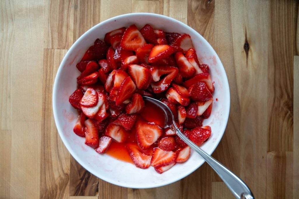 macerated strawberries in a white bowl