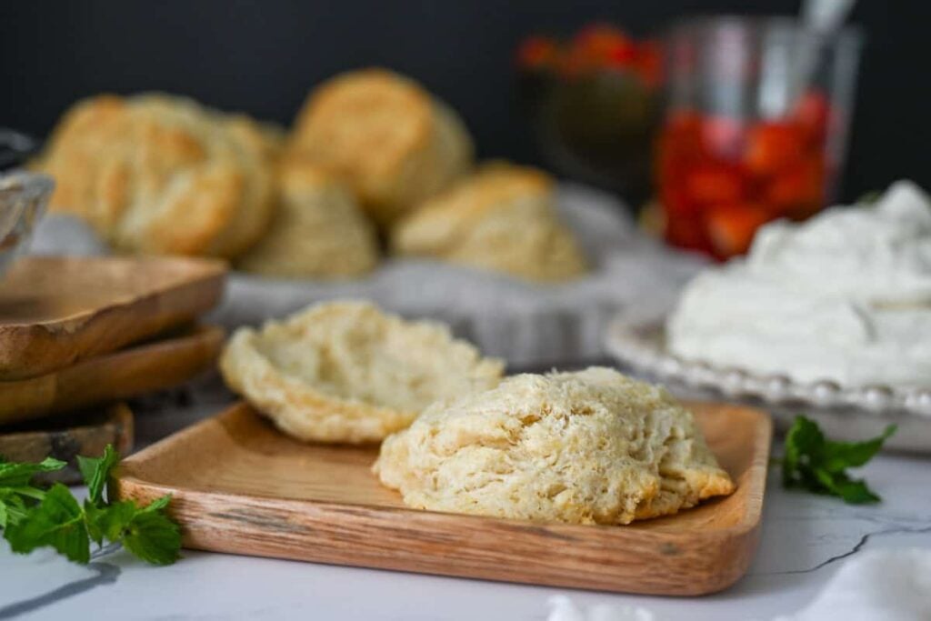a sourdough biscuit halved on a wood plate