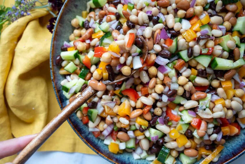cowboy caviar in a large bowl with a wooden spoon
