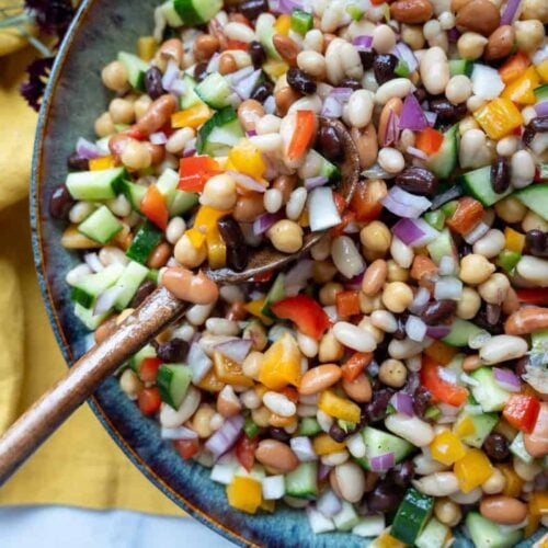 cowboy caviar in a large bowl with a wooden spoon