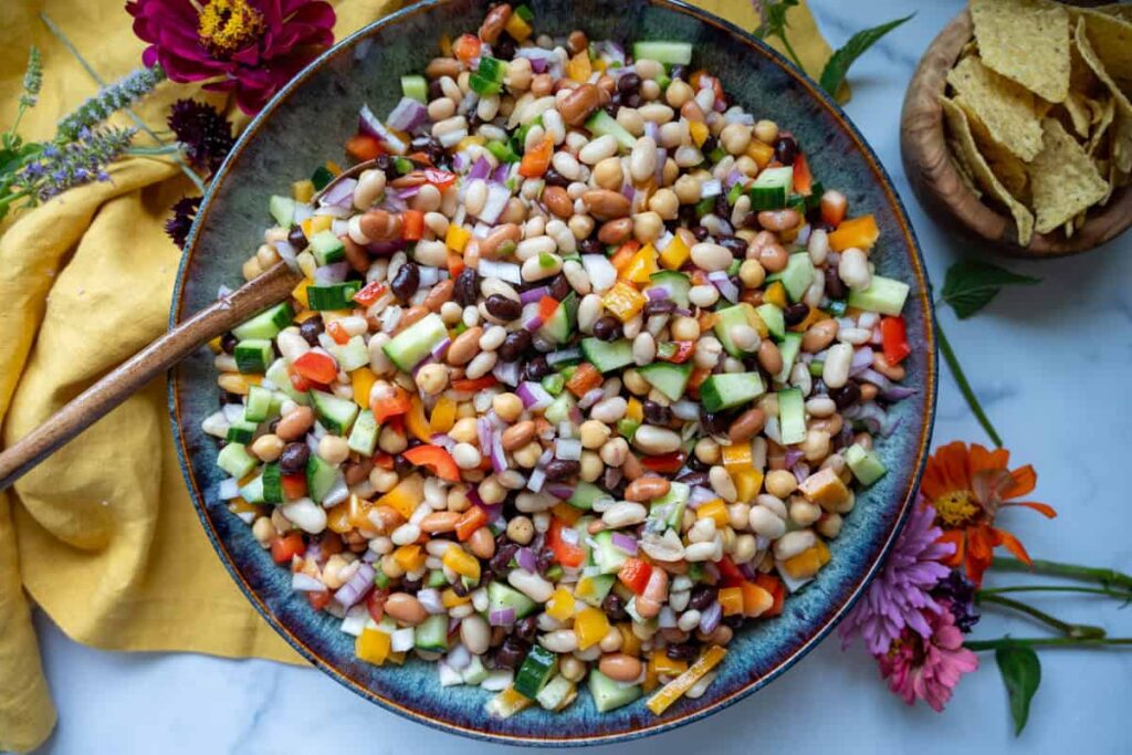 cowboy caviar in a large bowl with a wooden spoon