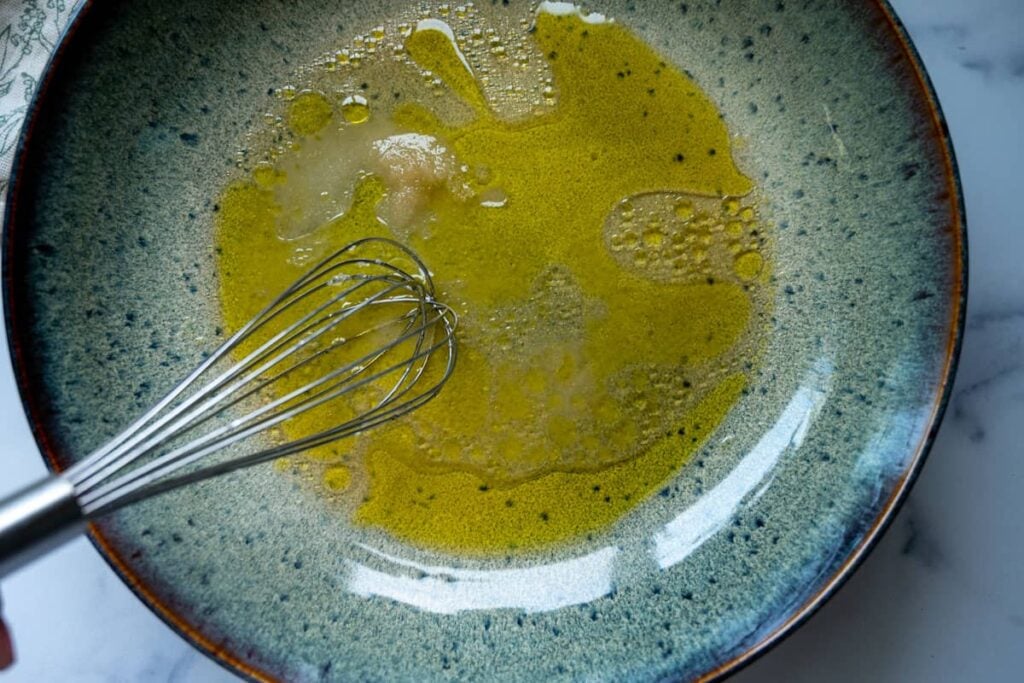 mixing oil and vinegar in a large, shallow bowl