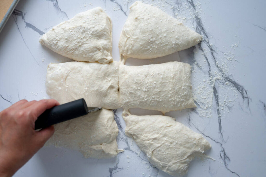 dividing sourdough ciabatta dough with a bench scraper