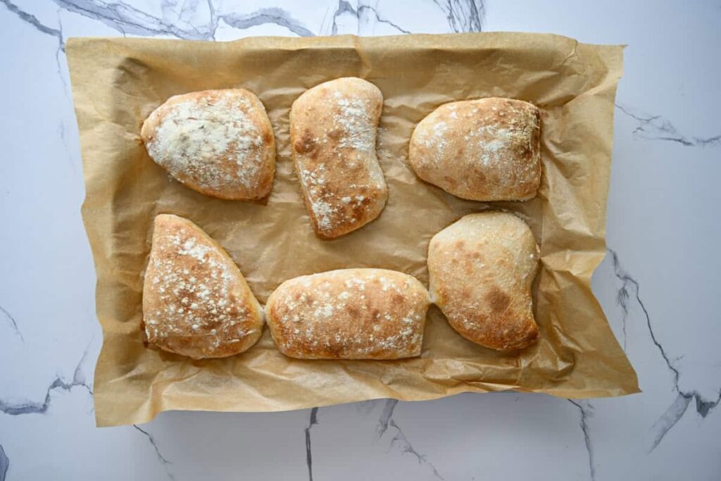 baked sourdough ciabatta bread on a parchment lined baking sheet