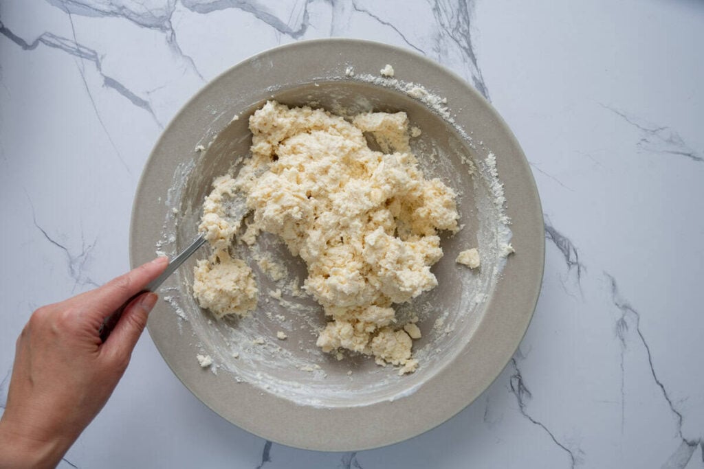 combining the wet and dry ingredients for sourdough peach cobbler