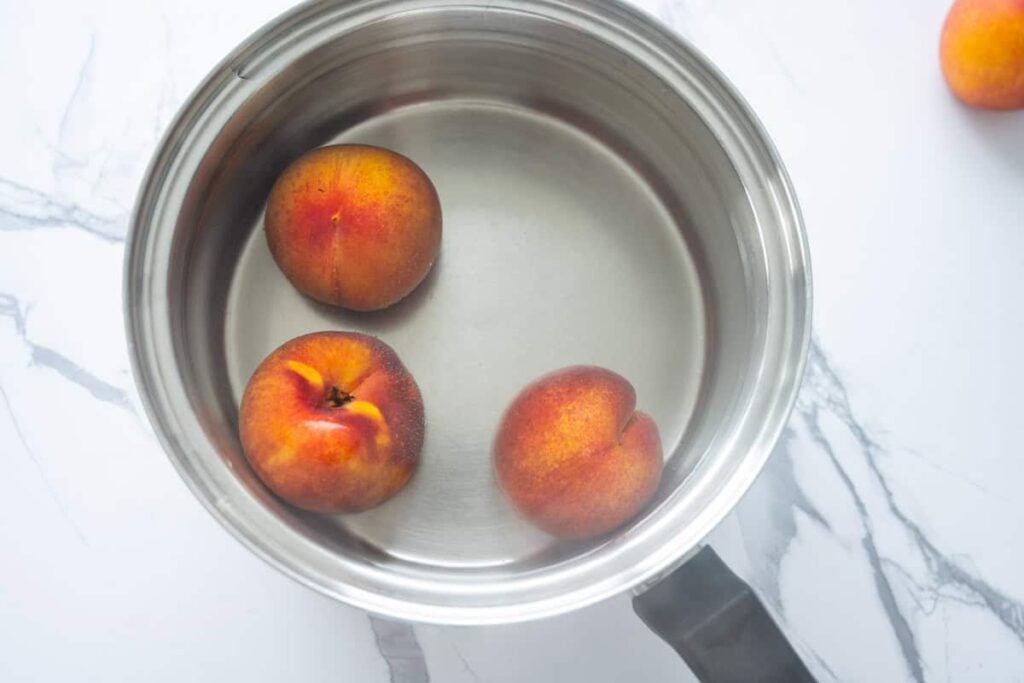 peaches in a pot of boiling water
