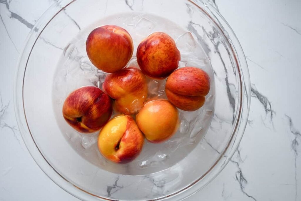 peaches in a bowl of ice water