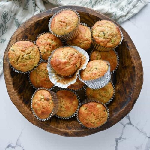 many one bowl sourdough zucchini muffins in a wooden bowl