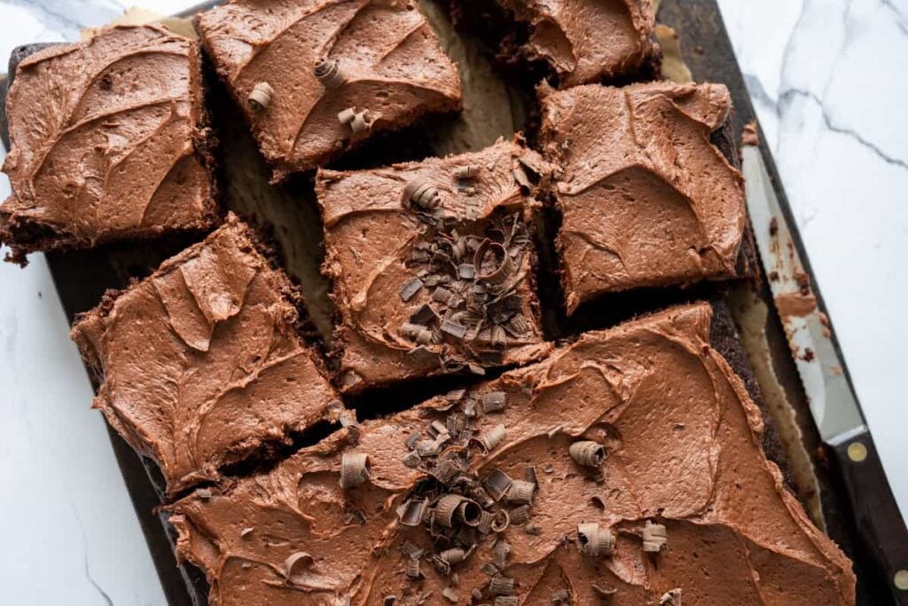 sourdough chocolate zucchini cake cut into pieces on a wooden board