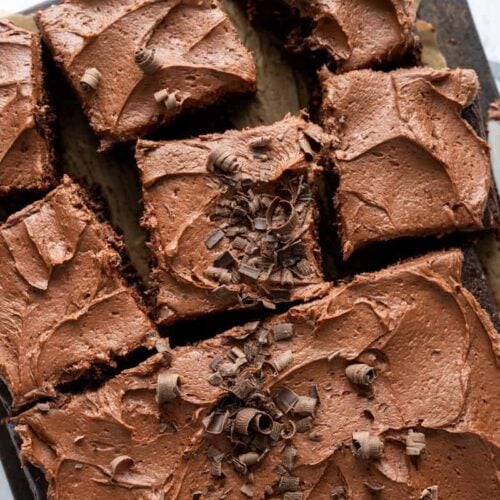 sourdough chocolate zucchini cake cut into pieces on a wooden board