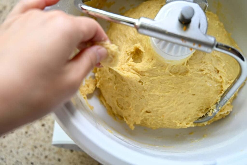 stretching the panettone dough in a stand mixer