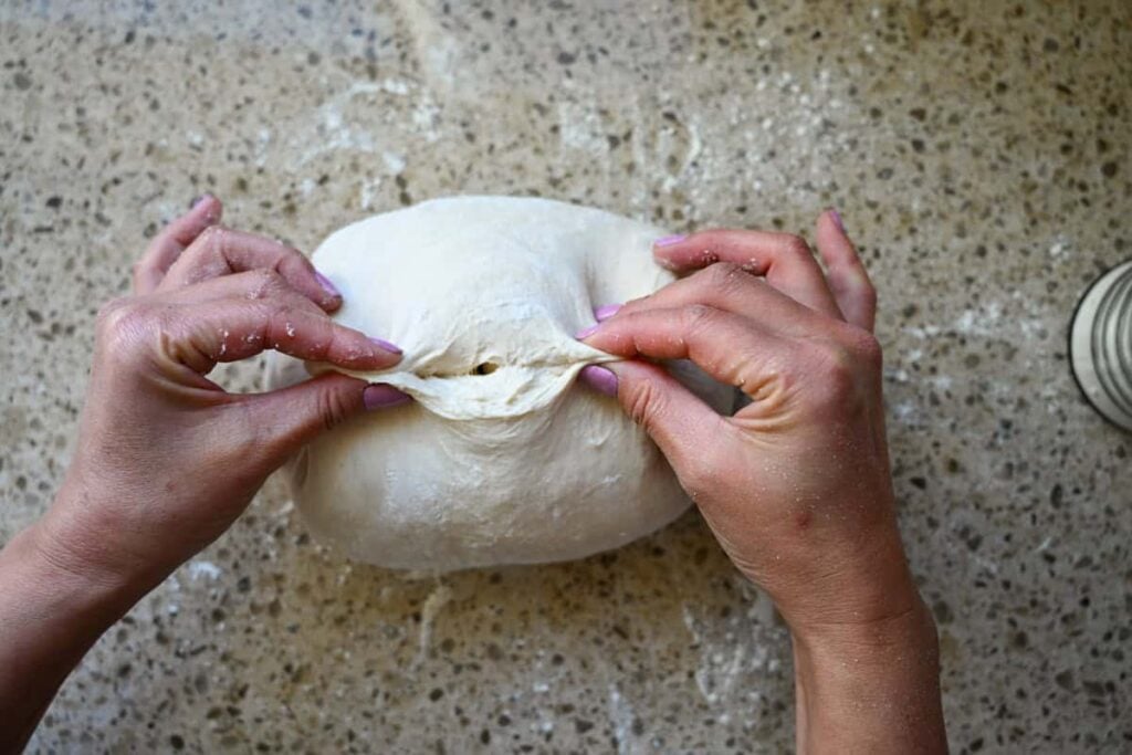 pinching close the seam on same day sourdough bread dough