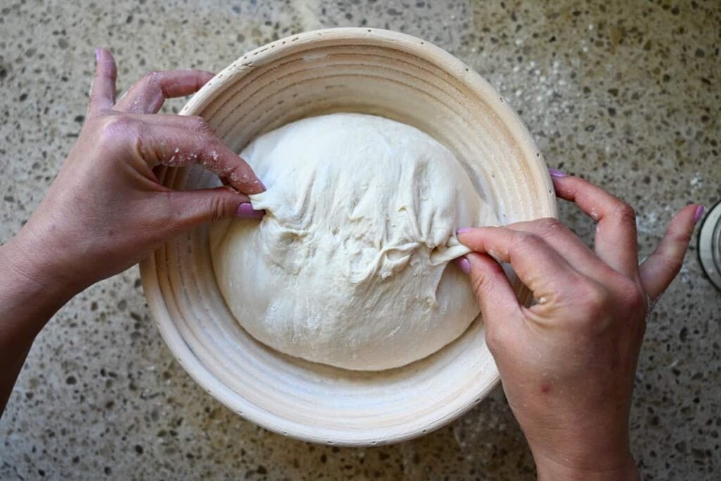 pinching the seams close on sourdough in a banneton