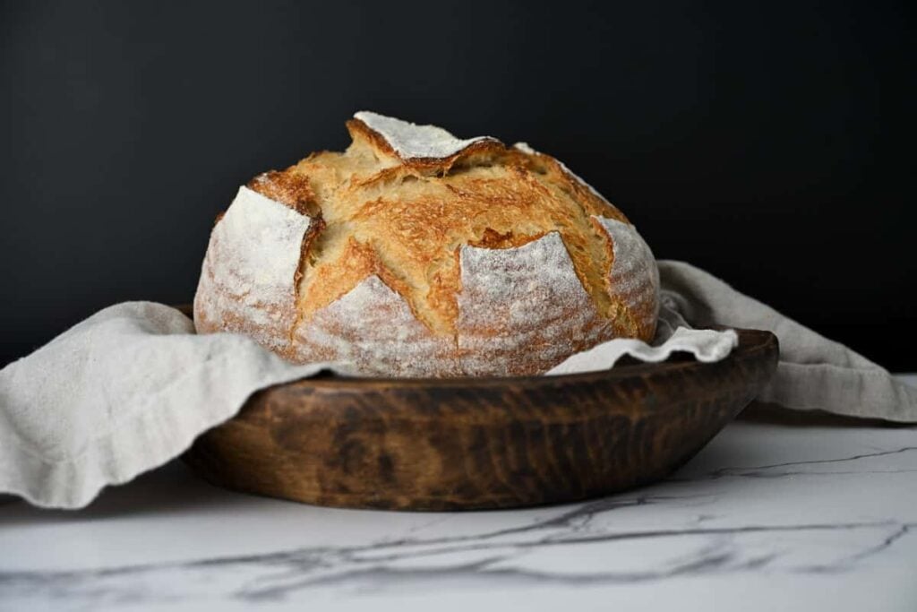 same day sourdough bread in a lined wooden bowl