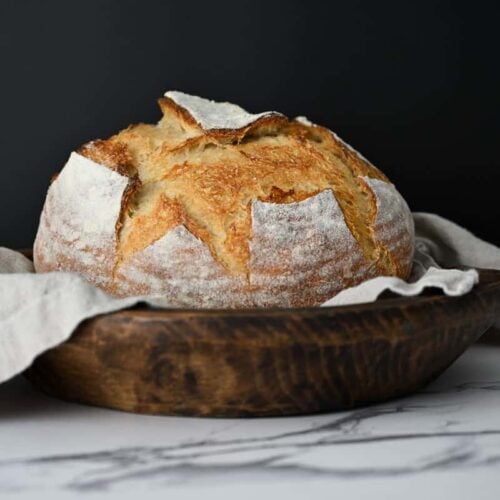 same day sourdough bread in a lined wooden bowl