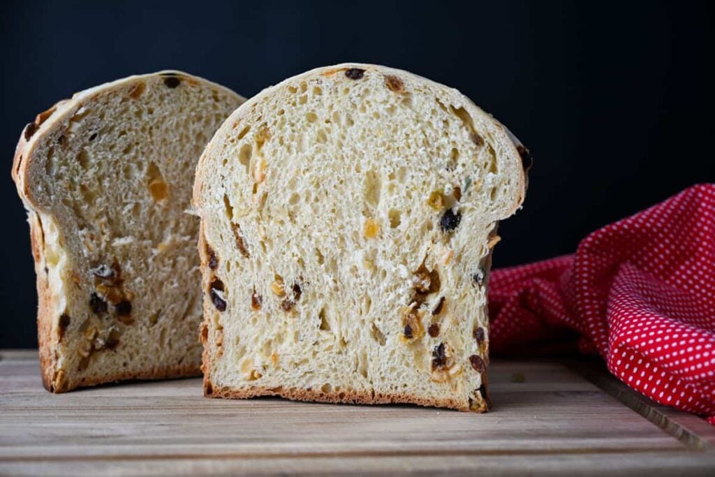 easy sourdough panettone bread cut in half on a wooden board